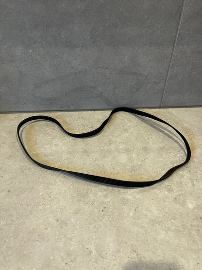 Black multi-rib serpentine belt on a light surface