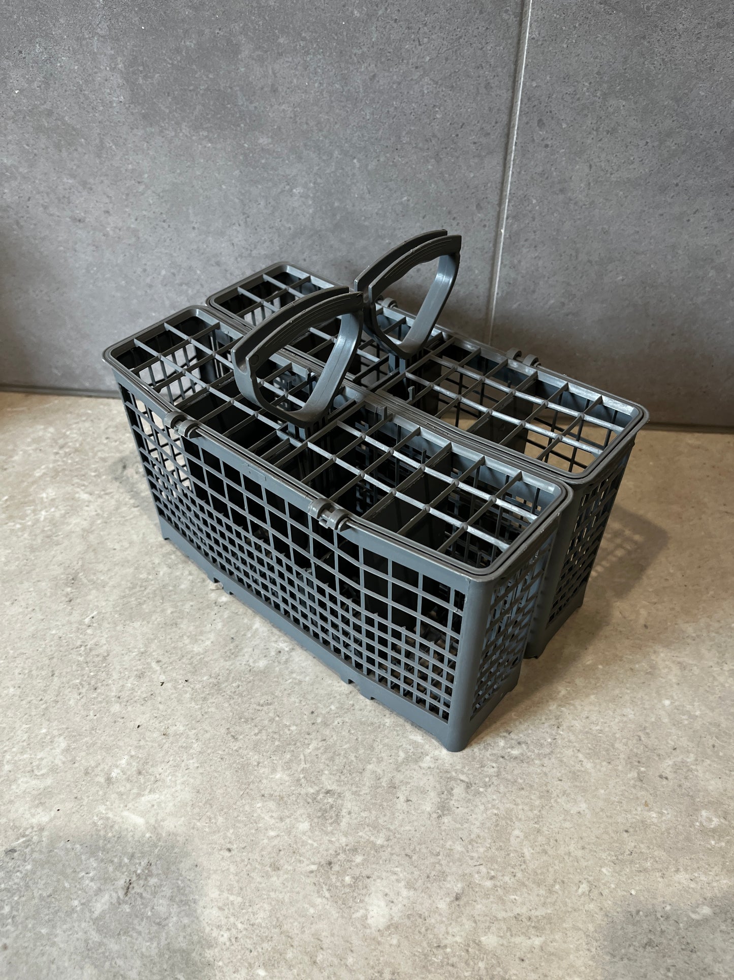 Dishwasher cutlery basket with handle and sectioned compartments
