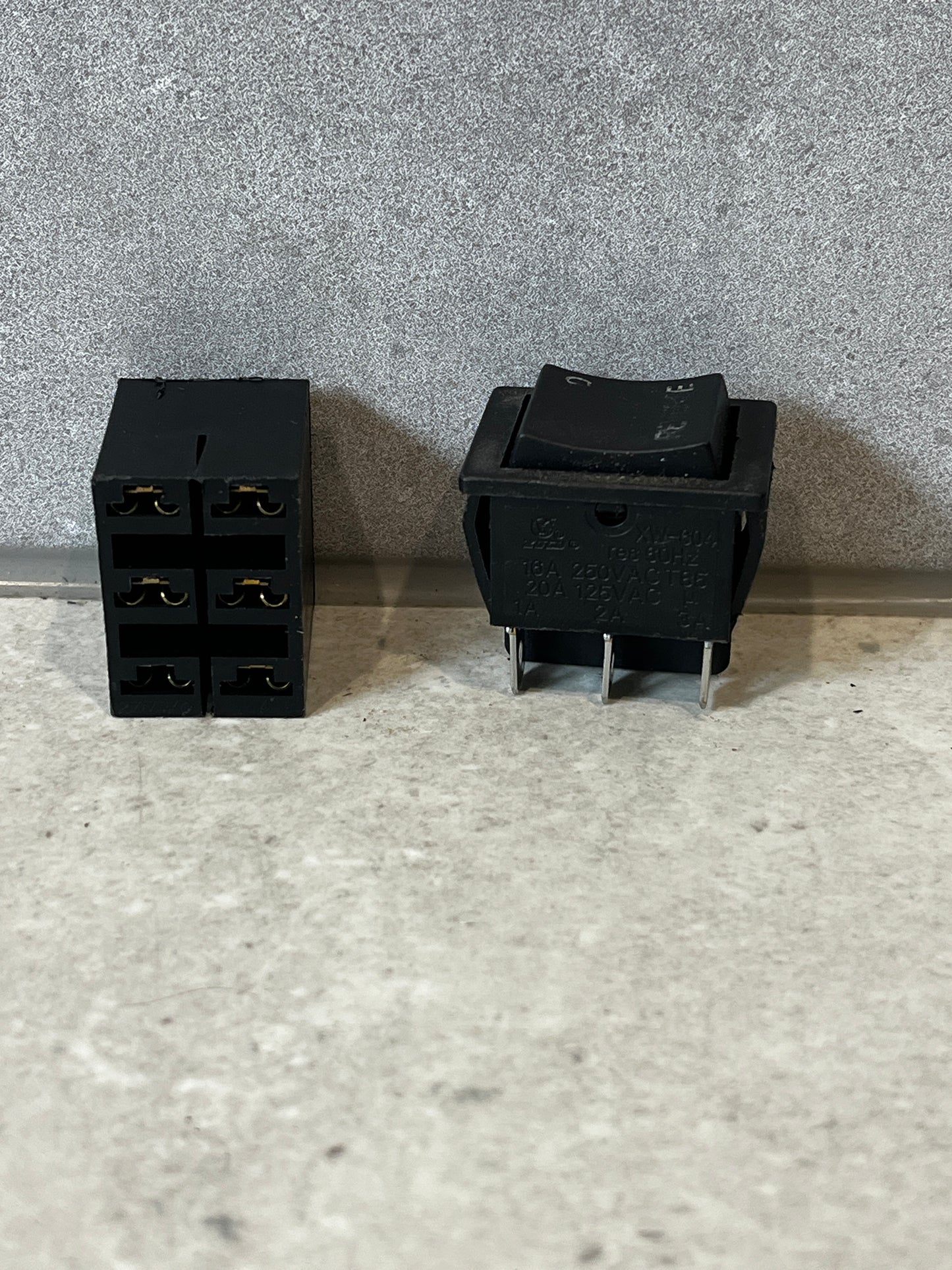 Dual view of heavy duty rocker switch with connector base