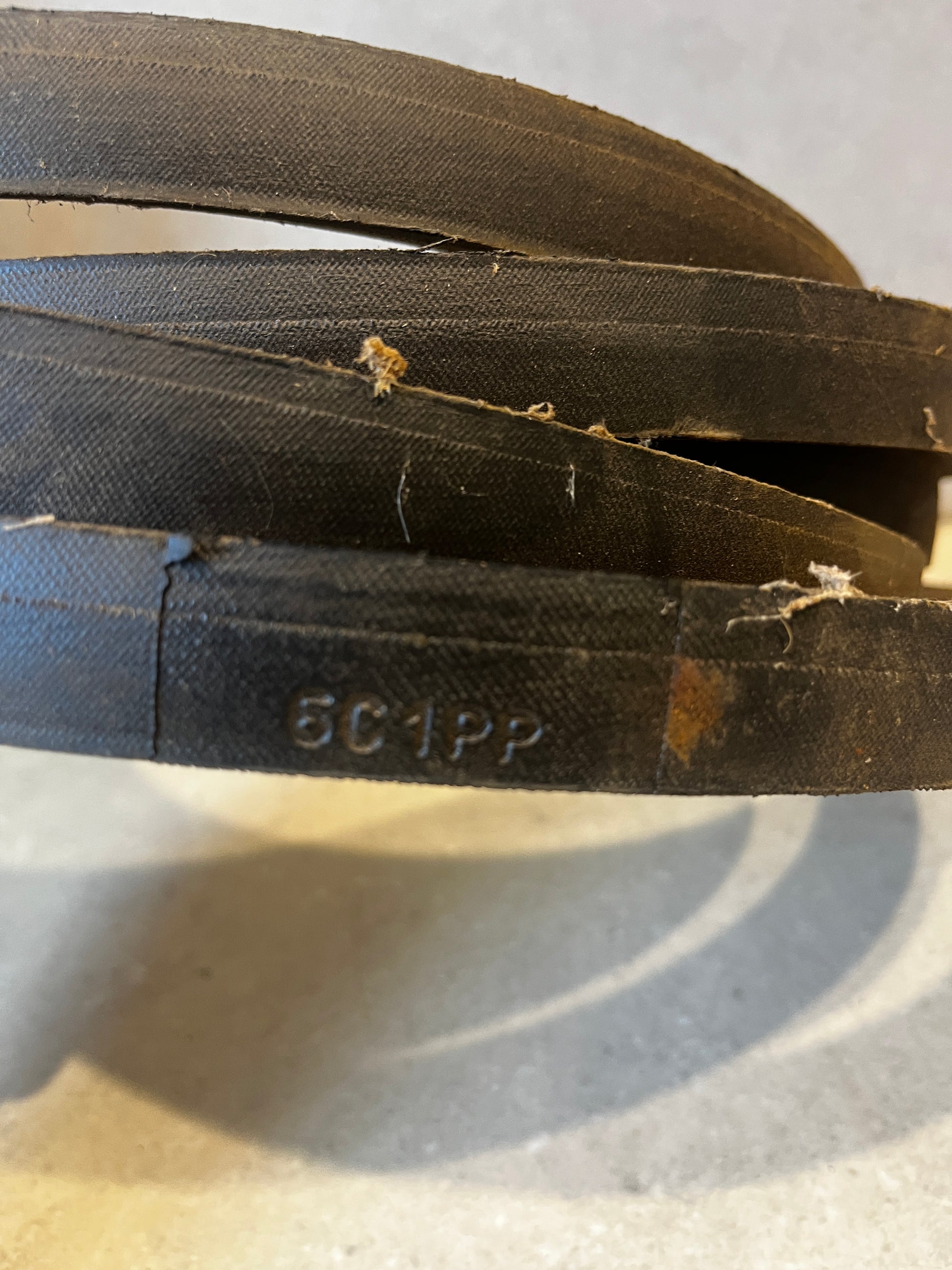 Close-up of durable industrial drive belt showing textured surface and model code