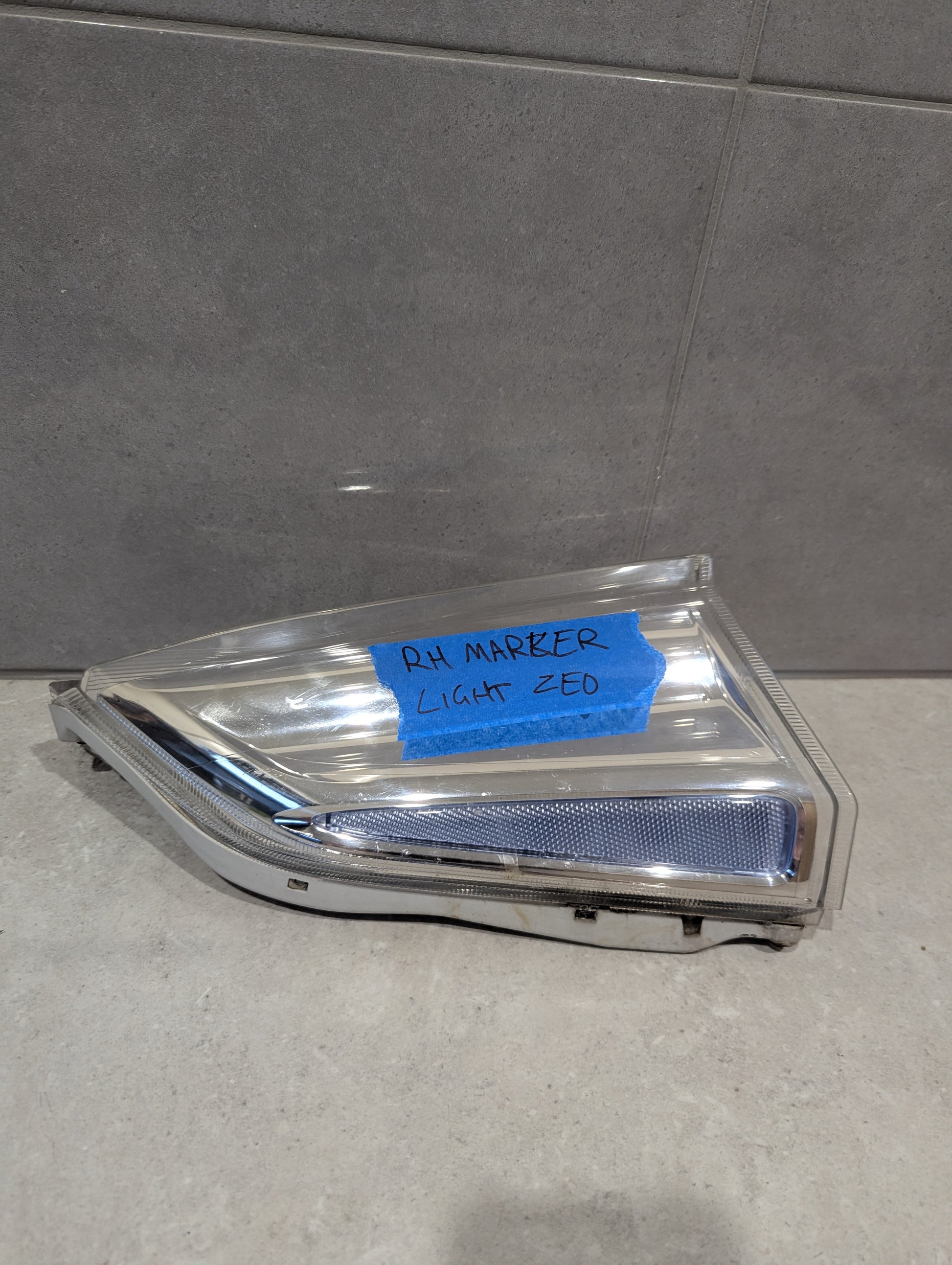 Front view of right side marker light assembly with clear lens and chrome trim