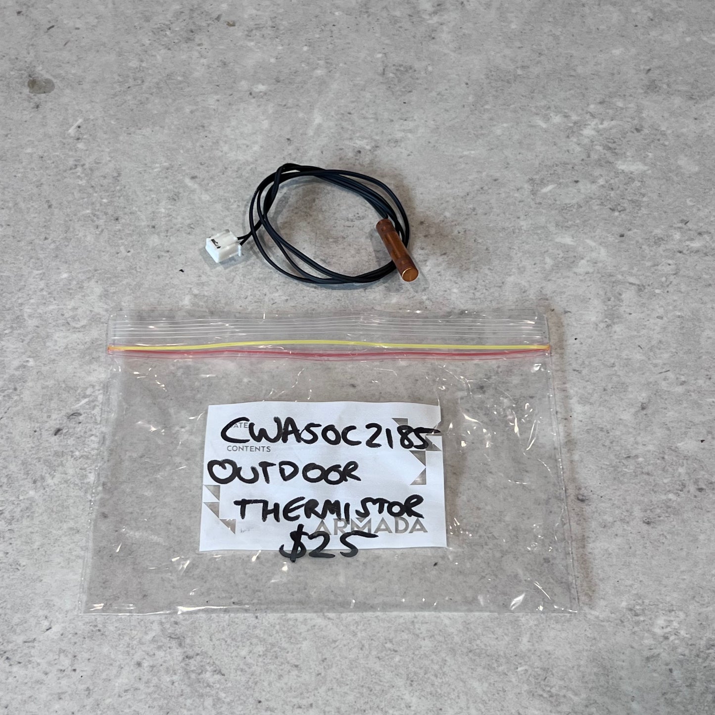 Outdoor thermistor with copper probe and connector, shown above labeled bag