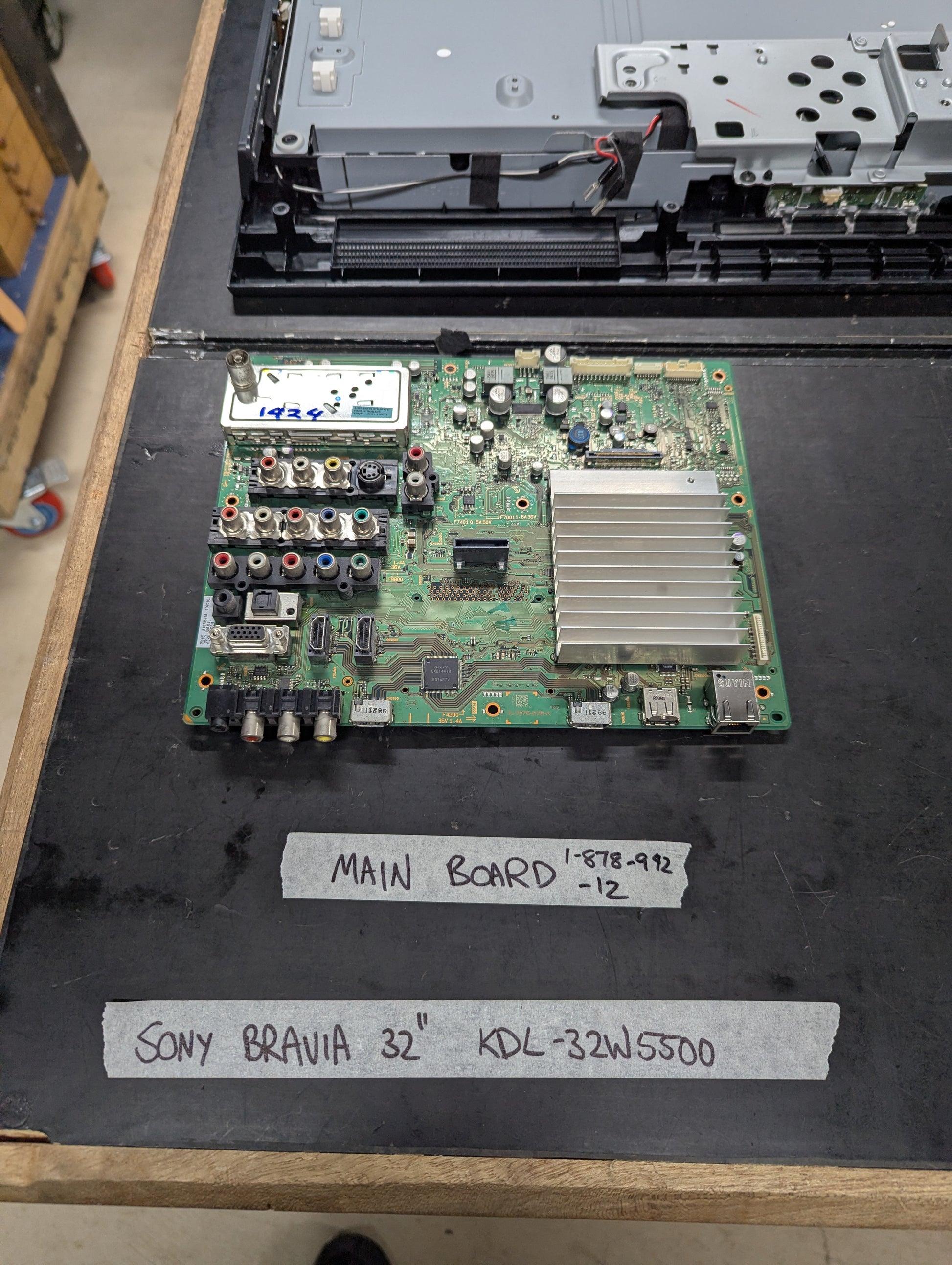 Sony Bravia 32 inch KDL-32W5500 main board with multiple AV and HDMI ports on a tech bench