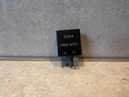 Black electrical relay with V23074 and PA66-GF25 marking