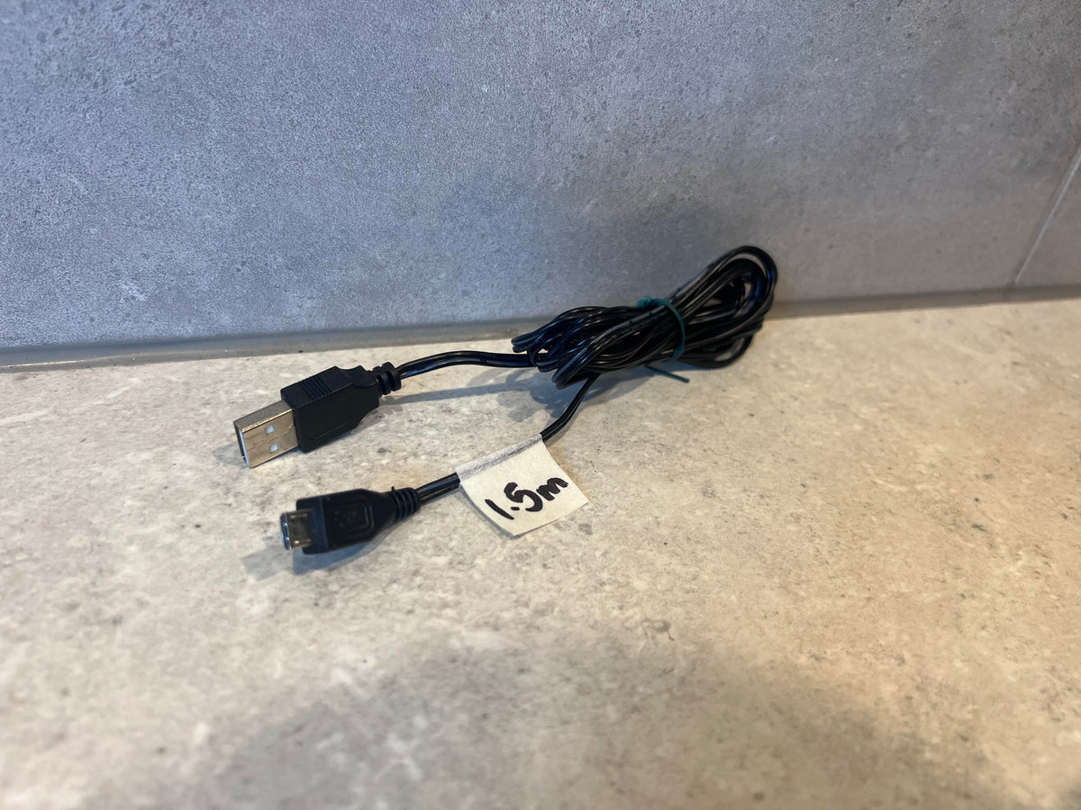 A 1.5-meter black USB to Mini-USB cable placed on a light-colored surface.