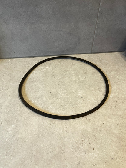 Black SPZ 1120 industrial V-belt on a light stone surface