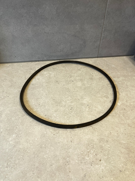 Black SPZ 1120 industrial V-belt on a light stone surface