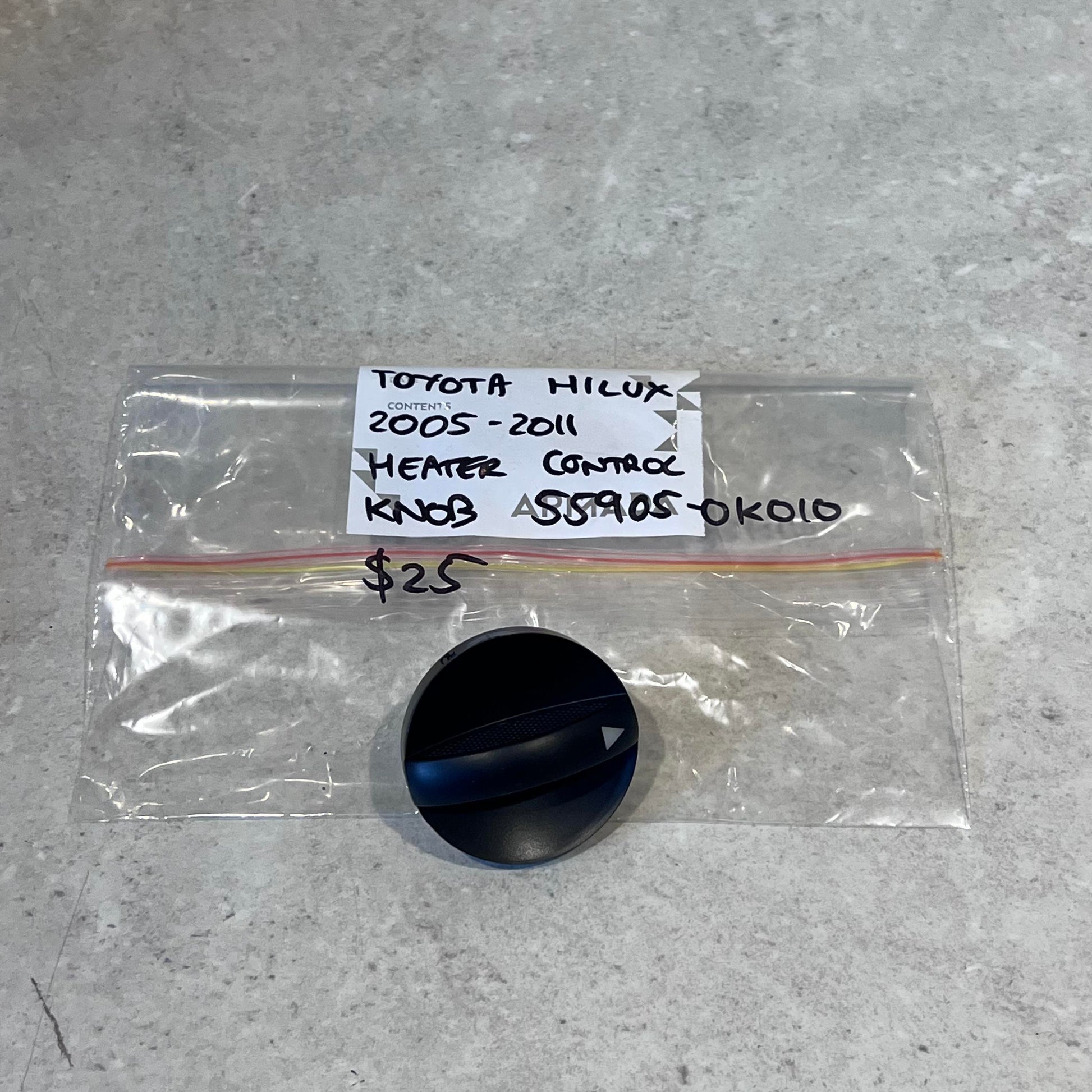 Toyota Hilux 2005-2011 heater control knob with labeled bag on gray surface