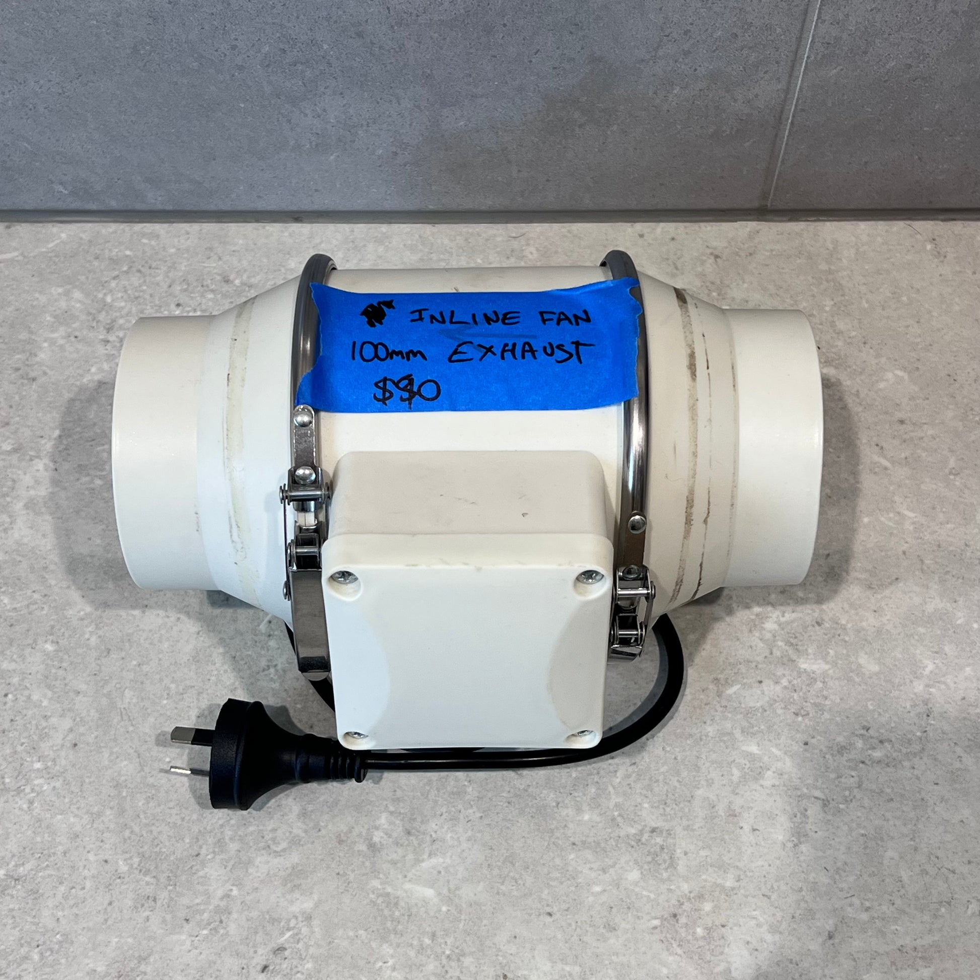 Top view of 100mm inline exhaust fan with plug and label