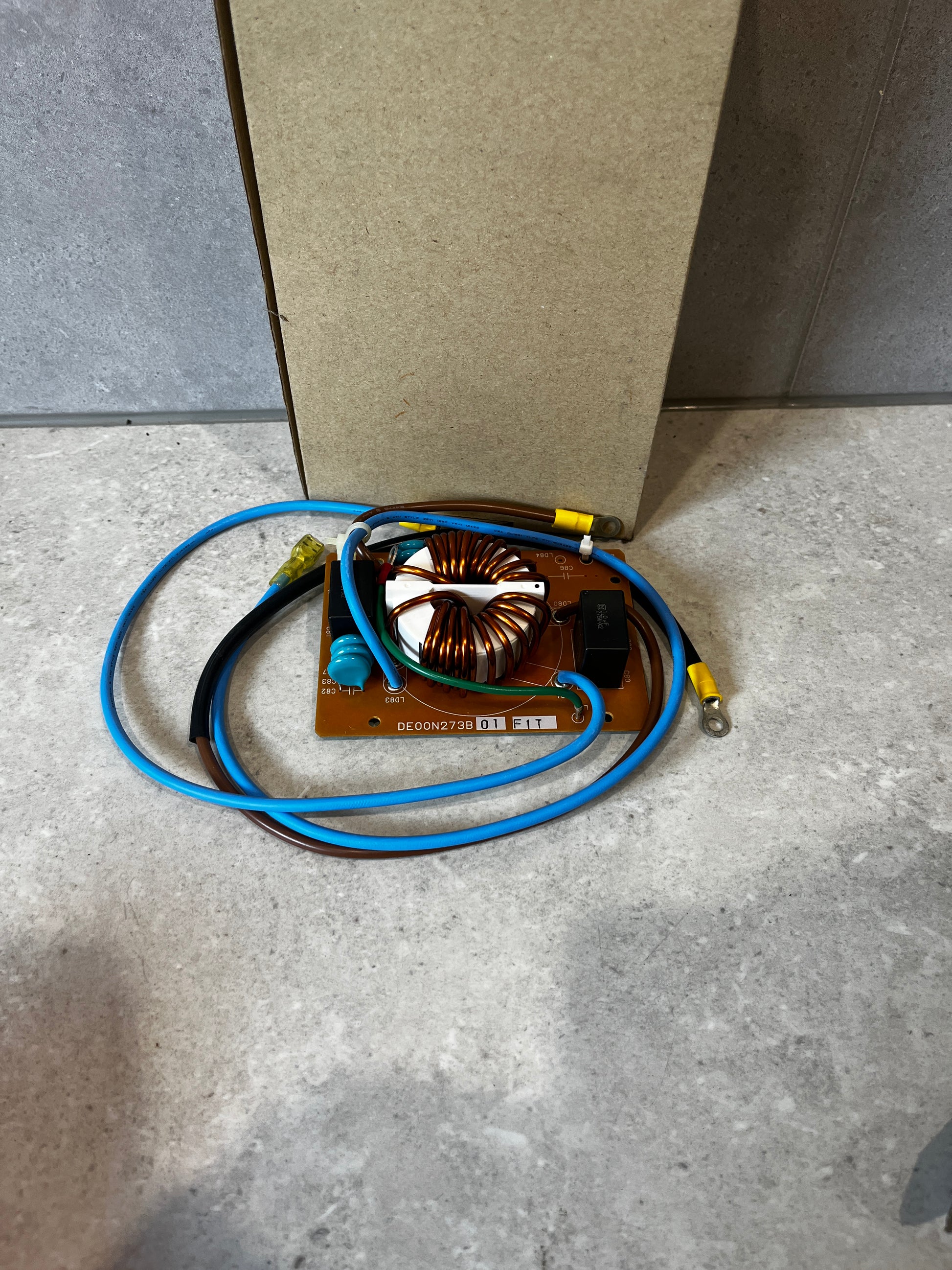 Noise Filter PC Board with attached wires on a stone surface