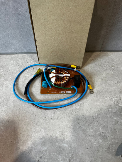 Noise Filter PC Board with attached wires on a stone surface