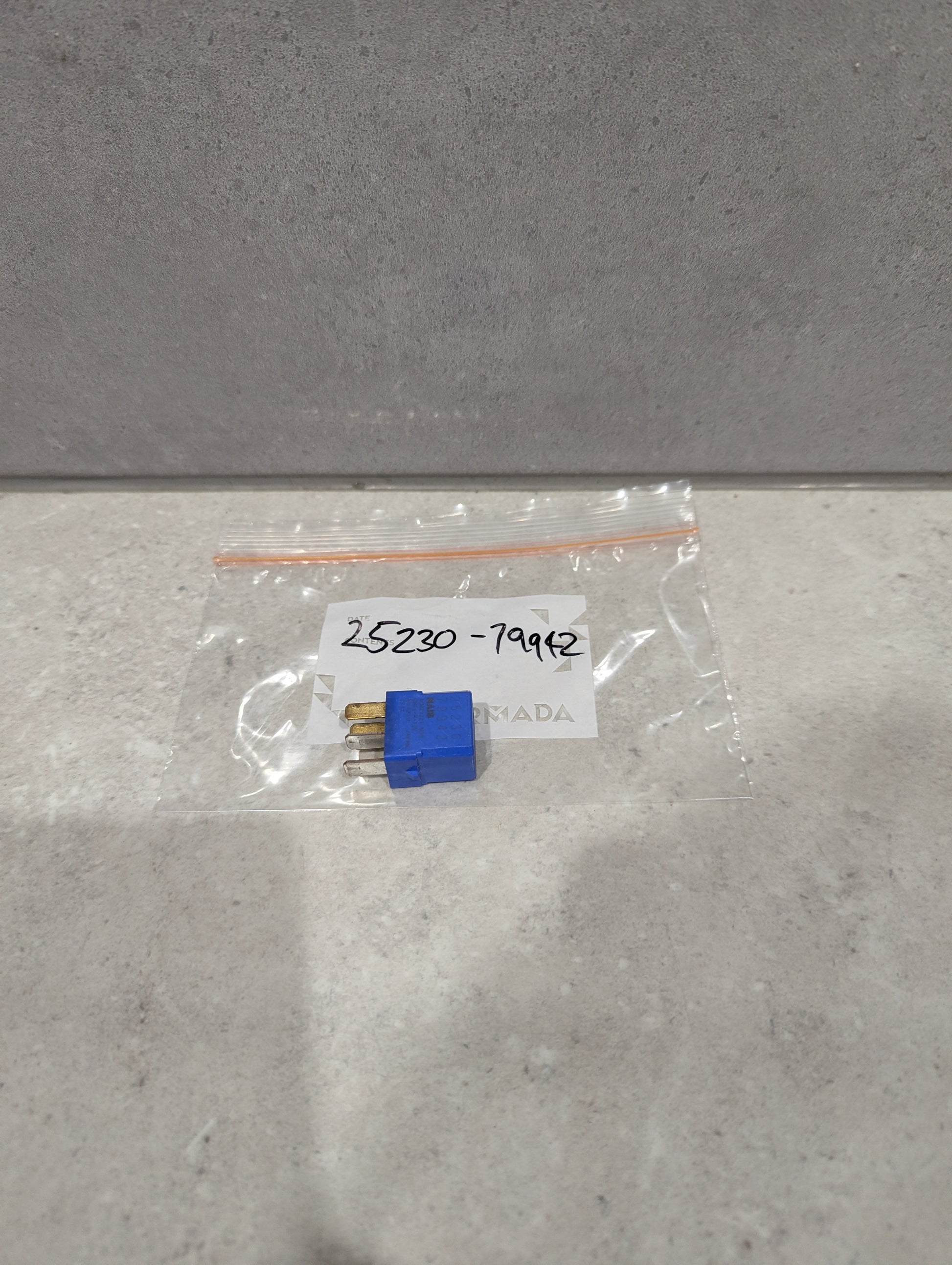 Blue automotive relay plug connector in clear plastic bag labeled 25230-79942
