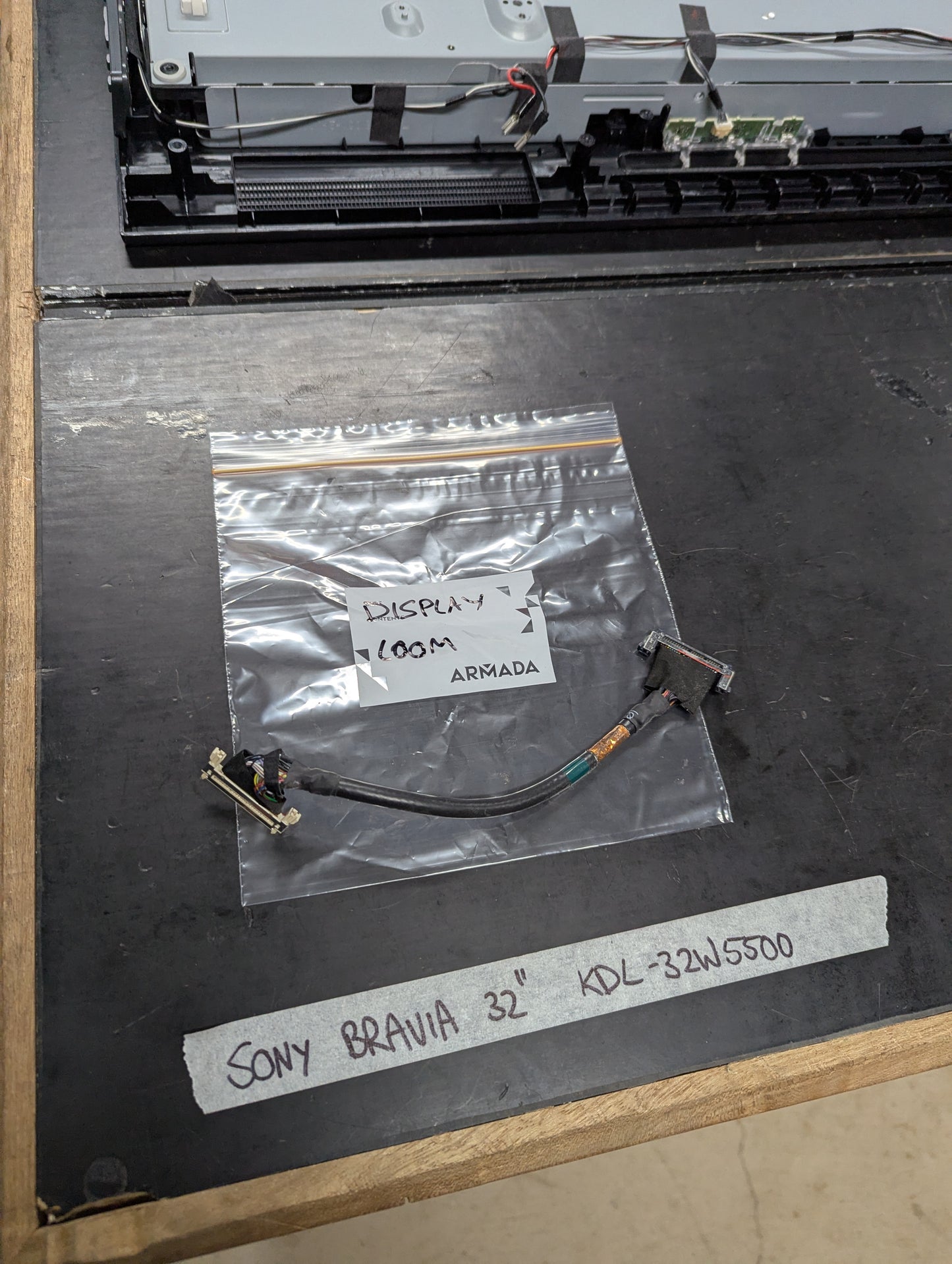 Sony Bravia KDL-32W5500 display cable in plastic bag on workbench