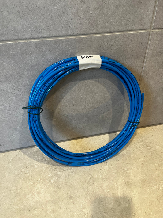 Coiled blue pneumatic tubing hose on tiled floor