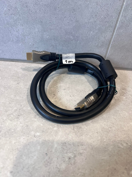 Coiled 1 meter black HDMI cable with gold-plated connectors on a light surface