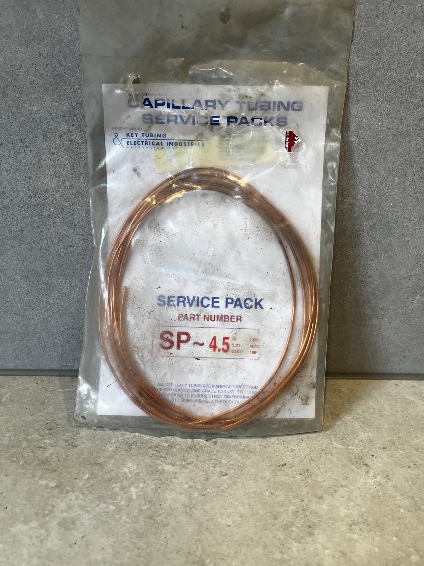 Front view of Capillary Tubing Service Pack SP-4.5 with copper coil in plastic packaging