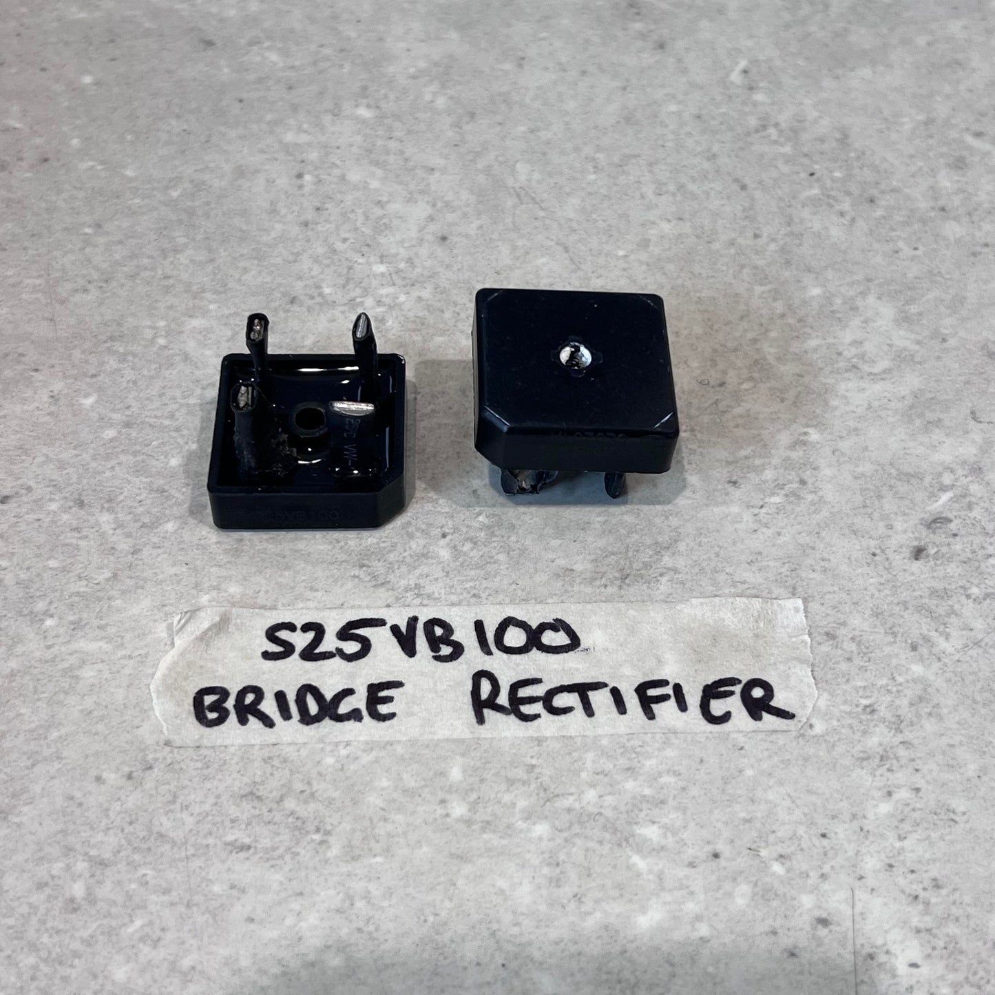S25VB100 bridge rectifier electronic component for CUT50 plasma cutter, two views on a gray surface