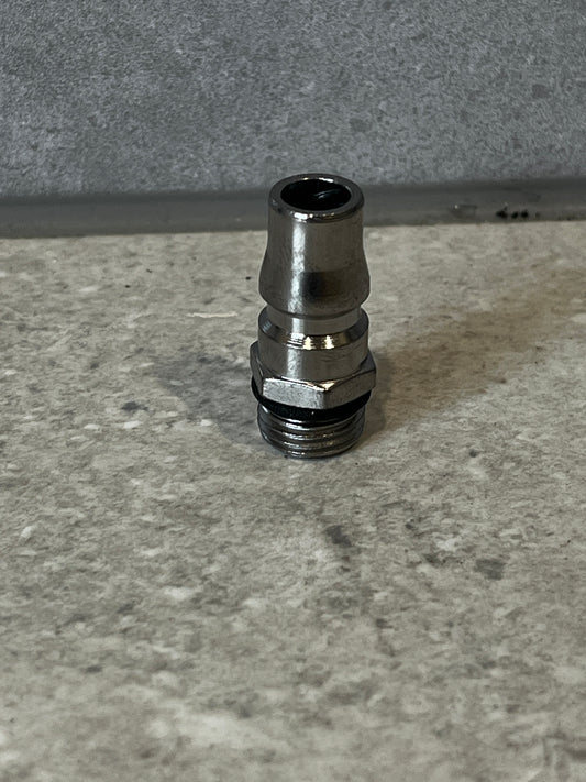 Stainless steel air compressor hose fitting on a stone surface