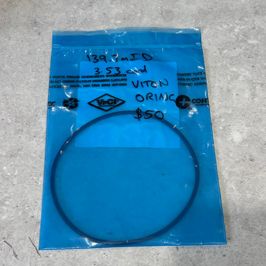 Viton O-ring with 139.7mm ID in blue VpCI packaging on gray surface