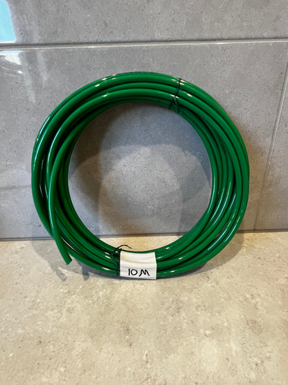 Coiled green polyurethane tubing coil labeled 10M on tiled surface