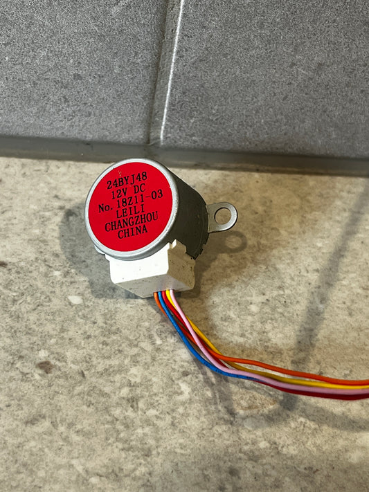 Close-up of 12V DC 24BYJ48 stepper motor with wiring and red cap