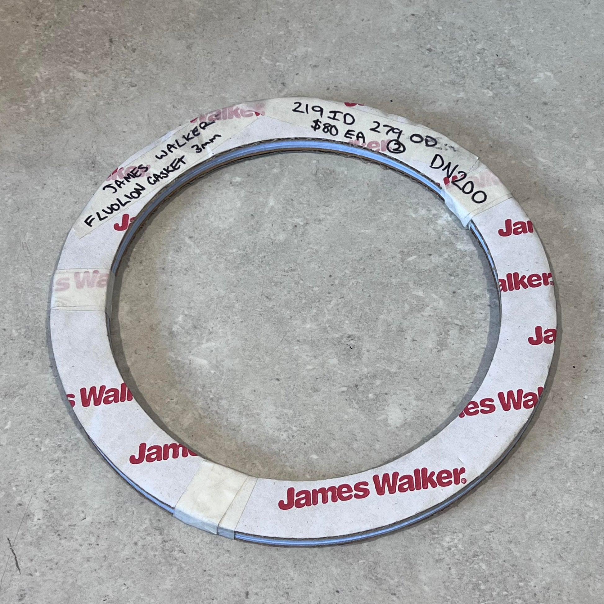 James Walker Fluolion gasket DN200 with labeling on a gray surface
