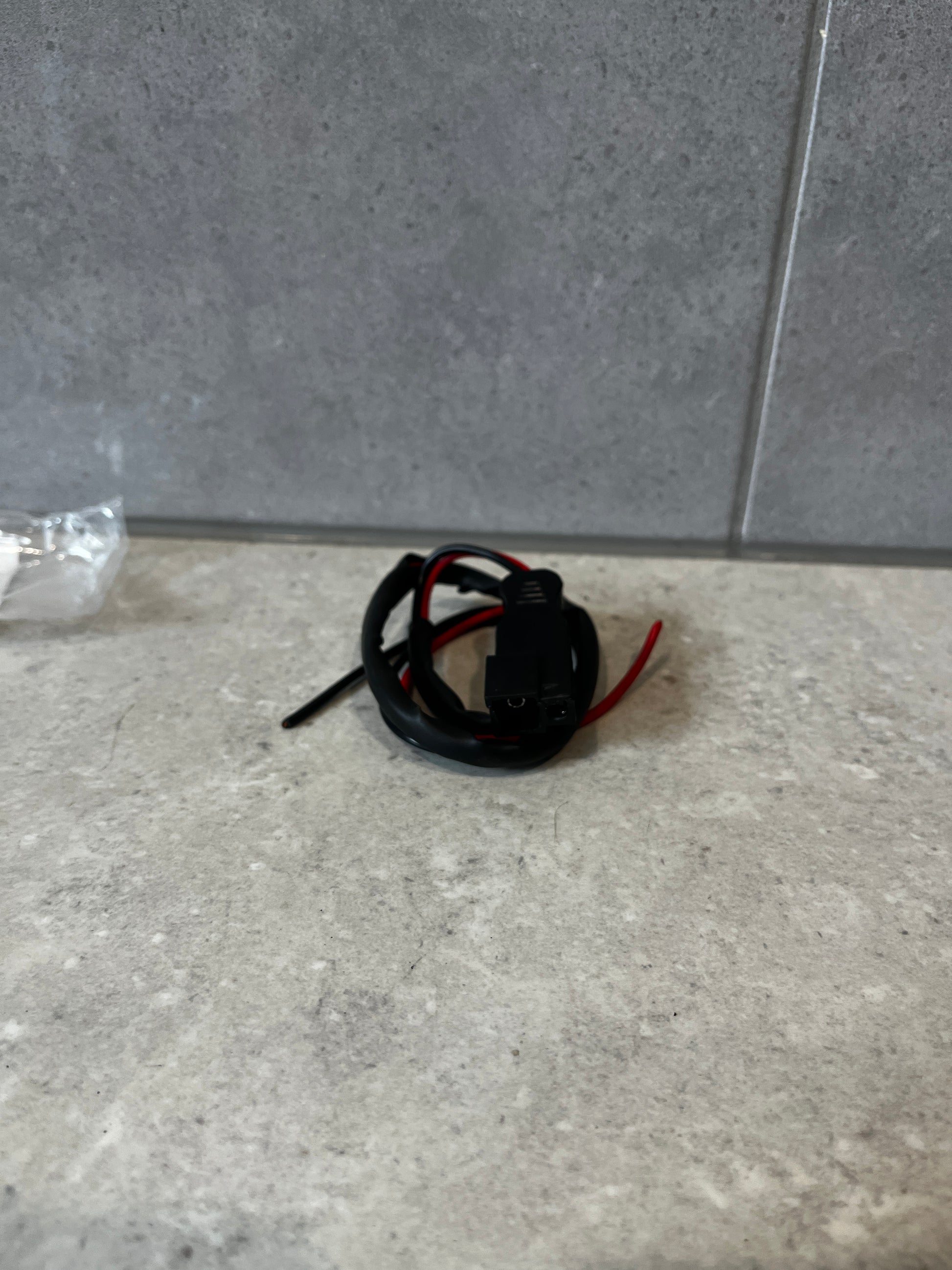 SAE to bare wire connector cable coiled on a countertop