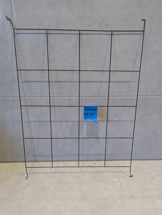 Rectangular metal wire grid panel on a concrete background