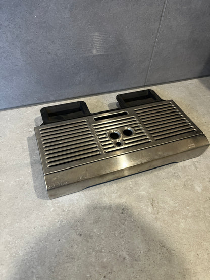 Stainless steel espresso drip tray with metal grid on top and black plastic collection trays.