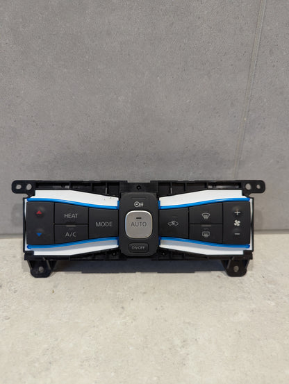 Front view of automotive climate control panel assembly with multiple labeled buttons