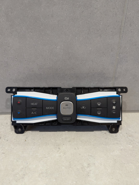 Front view of automotive climate control panel assembly with multiple labeled buttons