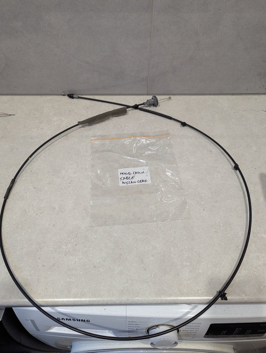 Replacement hood latch cable for Nissan Leaf vehicle displayed on a counter.