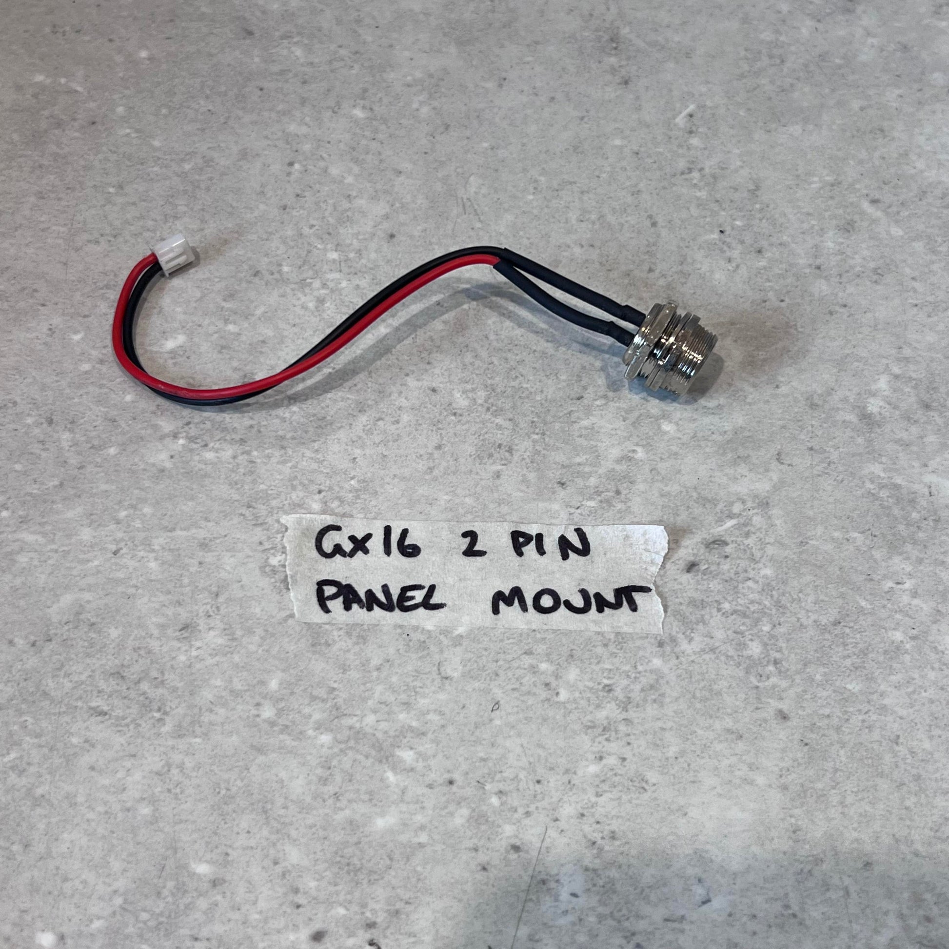 GX16 2 Pin Panel Mount Connector with wire leads on gray surface