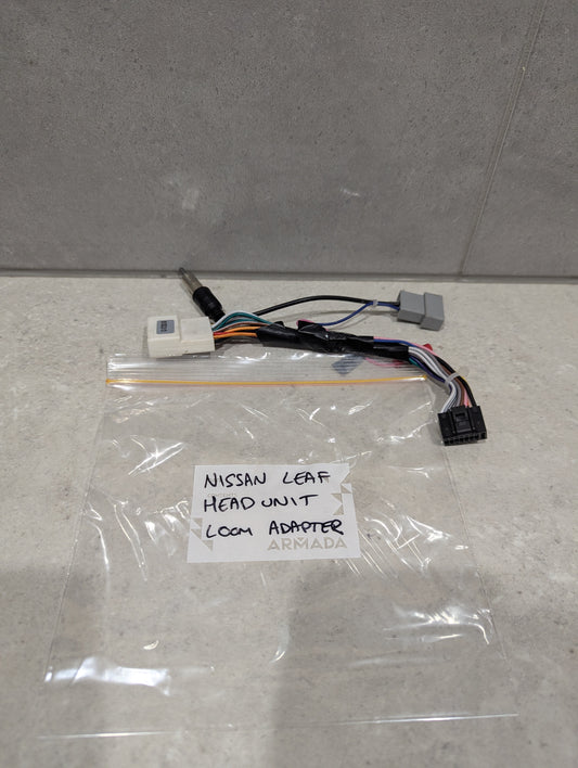 Nissan Leaf head unit loom adapter wiring harness on a countertop with labeled bag
