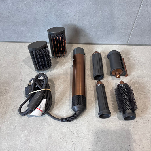 Dyson Airwrap set with multiple styling attachments on a countertop