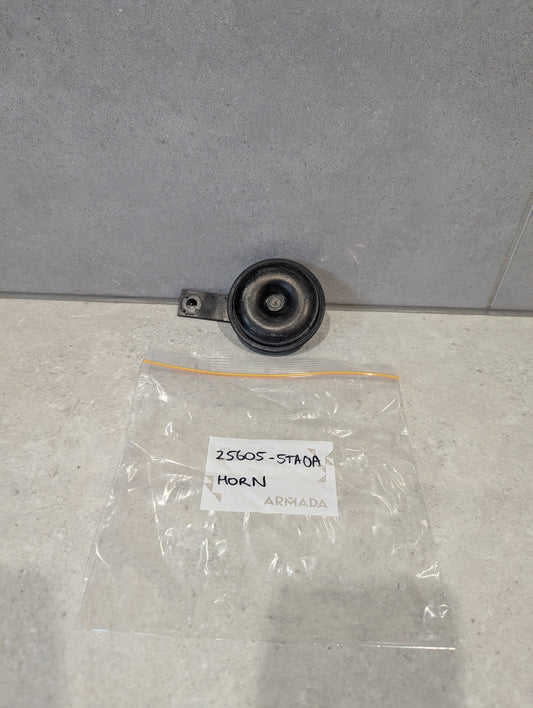 Black round vehicle horn unit with labeled ARMADA bag