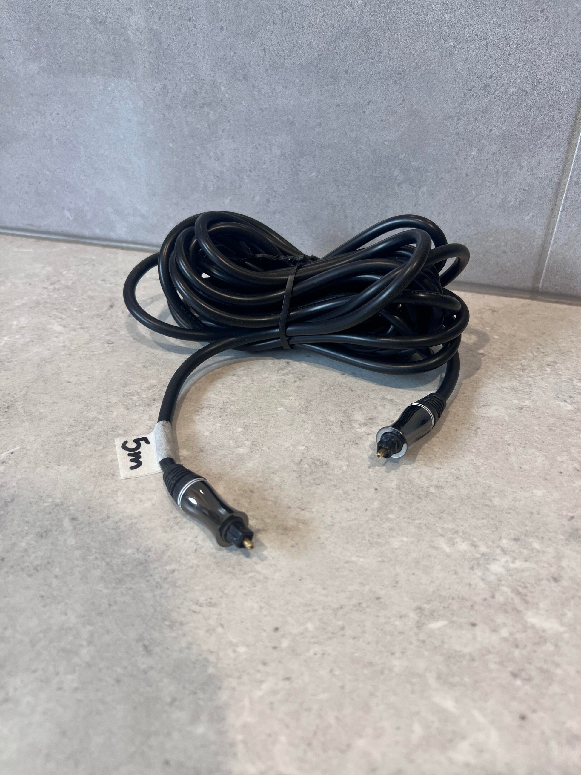Digital optical audio cable with Toslink connectors on a counter
