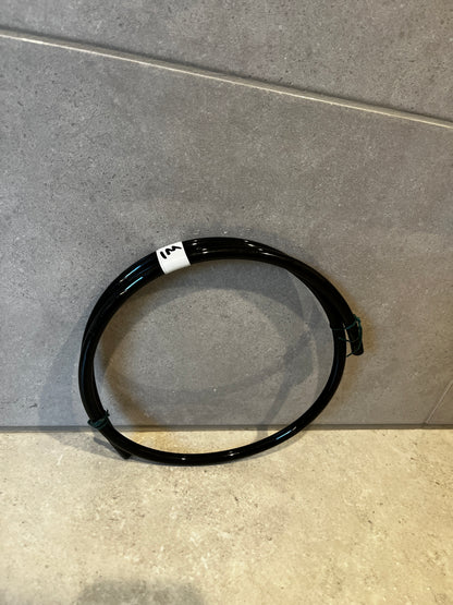 Black polyurethane tubing coiled on floor