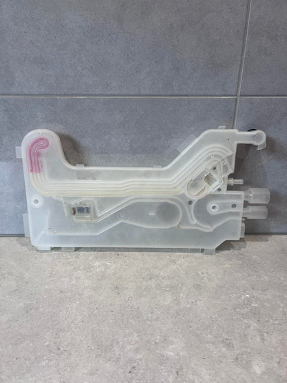Transparent dishwasher water inlet valve with molded channels on tiled surface