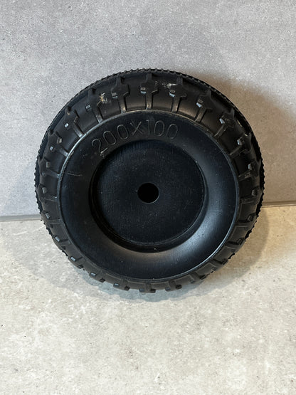 200x100 solid black rubber replacement wheel on gray surface