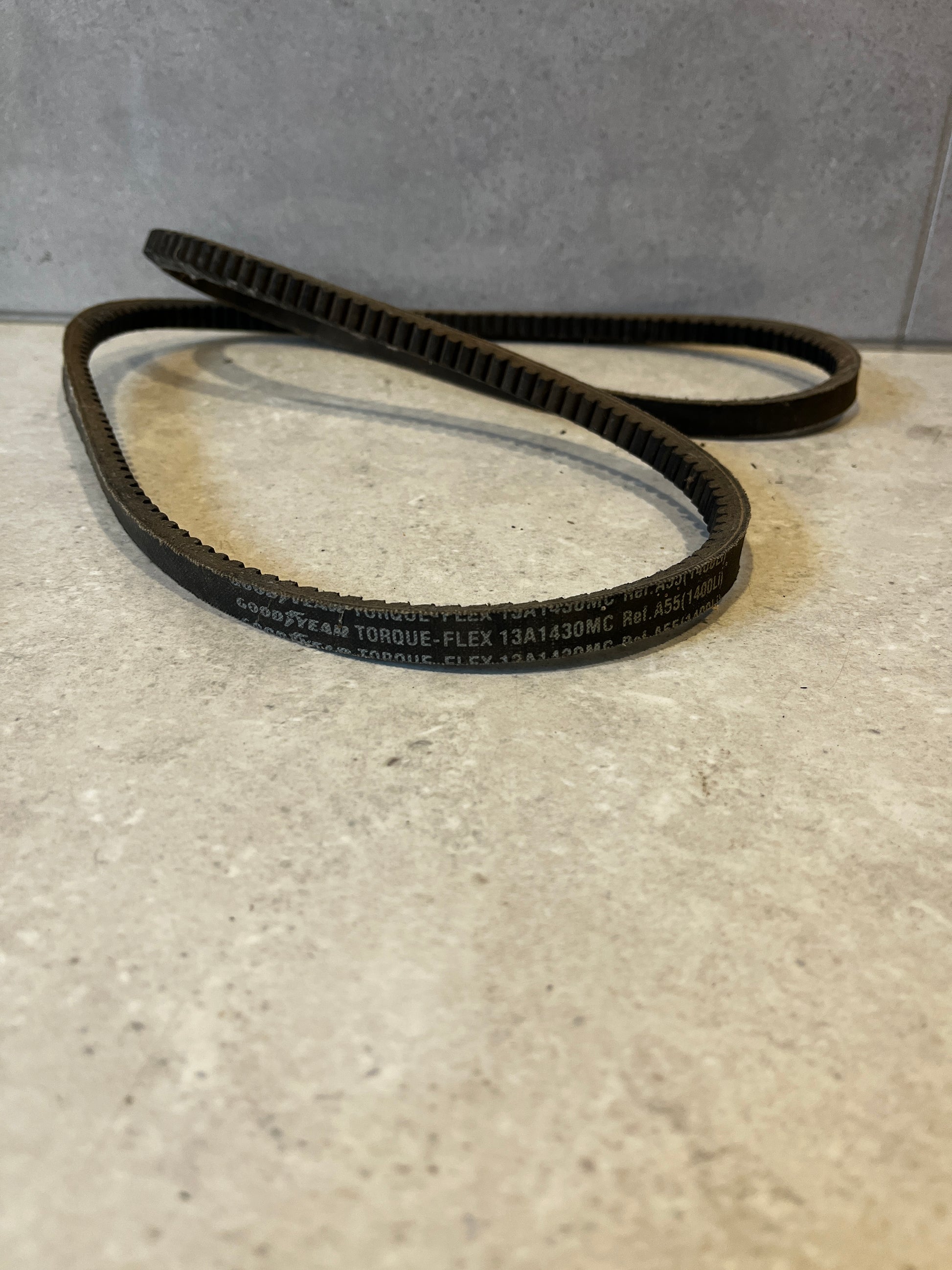 Goodyear Torque-Flex industrial V-belt close-up on gray surface