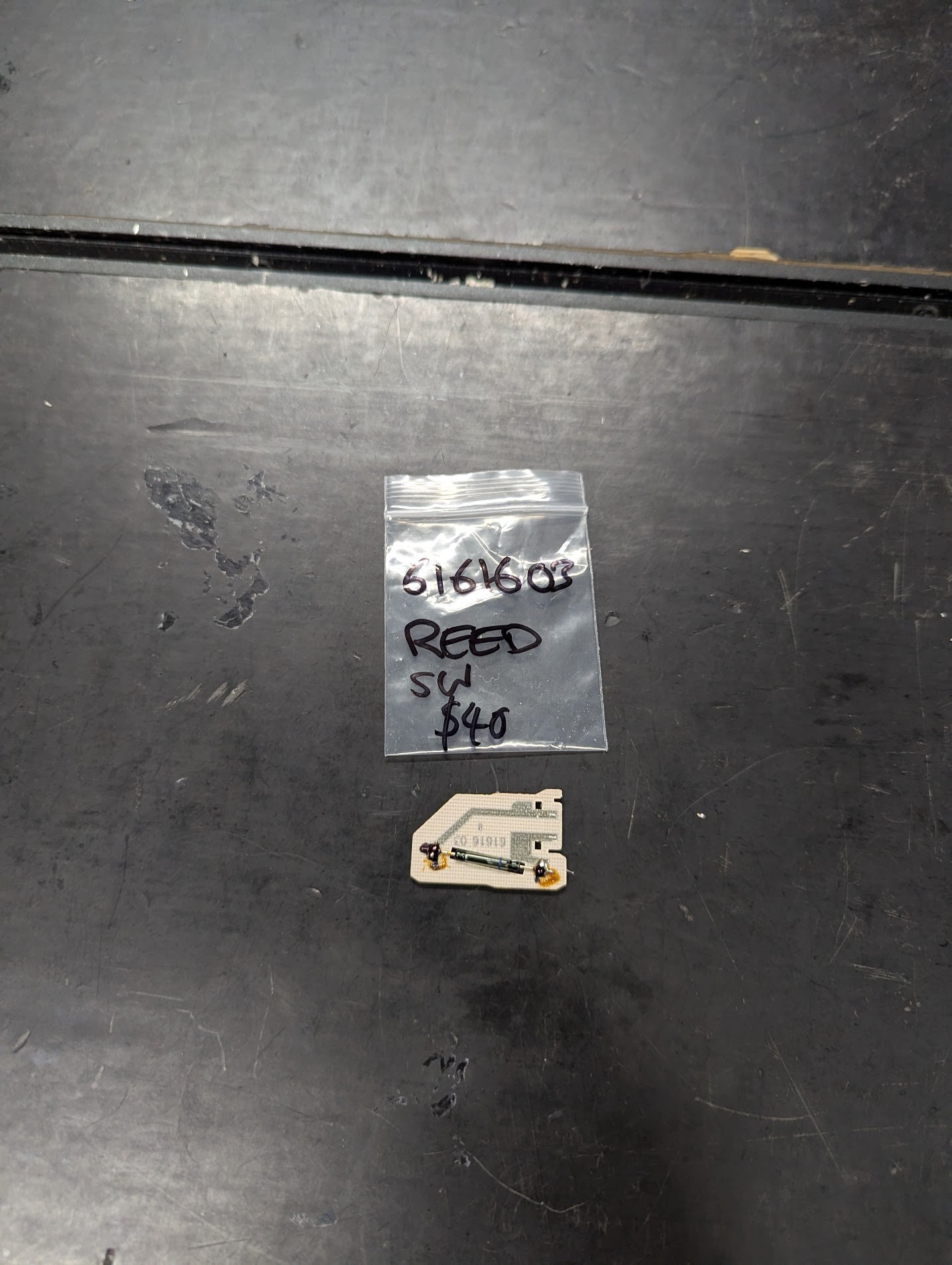 Reed Switch Sensor part 5161603 with labeled bag on a dark surface