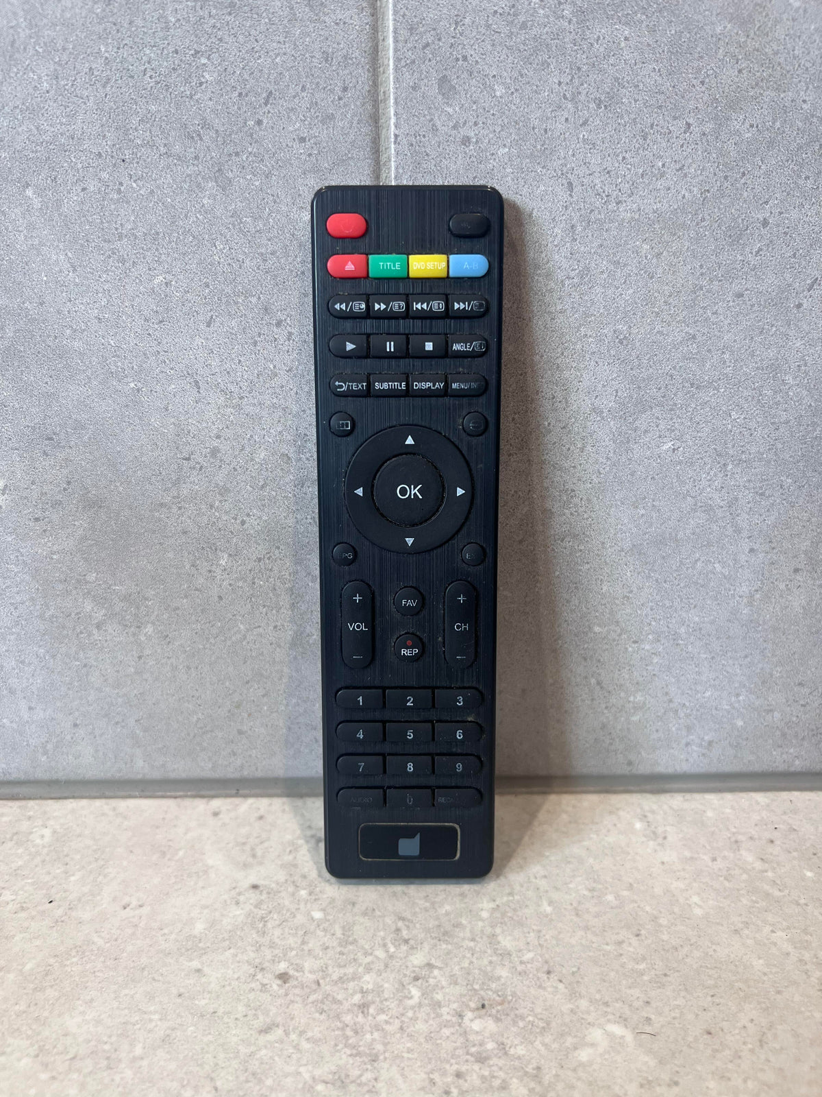 Universal TV and DVD remote control with colored shortcut buttons and numeric keypad