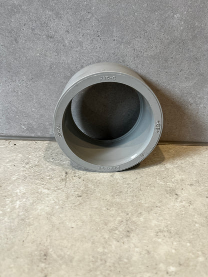 Gray PVC pipe coupling socket adapter front view