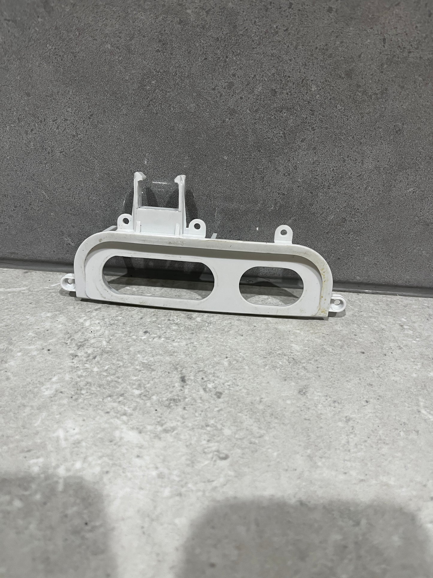White plastic blender control panel frame with two button openings and mounting holes
