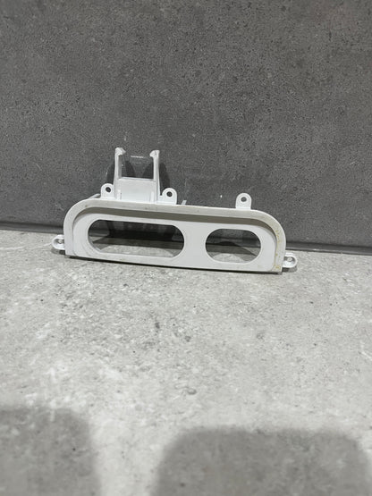 White plastic blender control panel frame with two button openings and mounting holes
