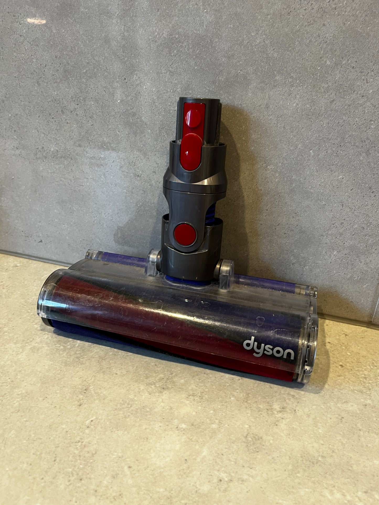 Dyson vacuum cleaner brush head attachment, grey and red plastic with clear cover