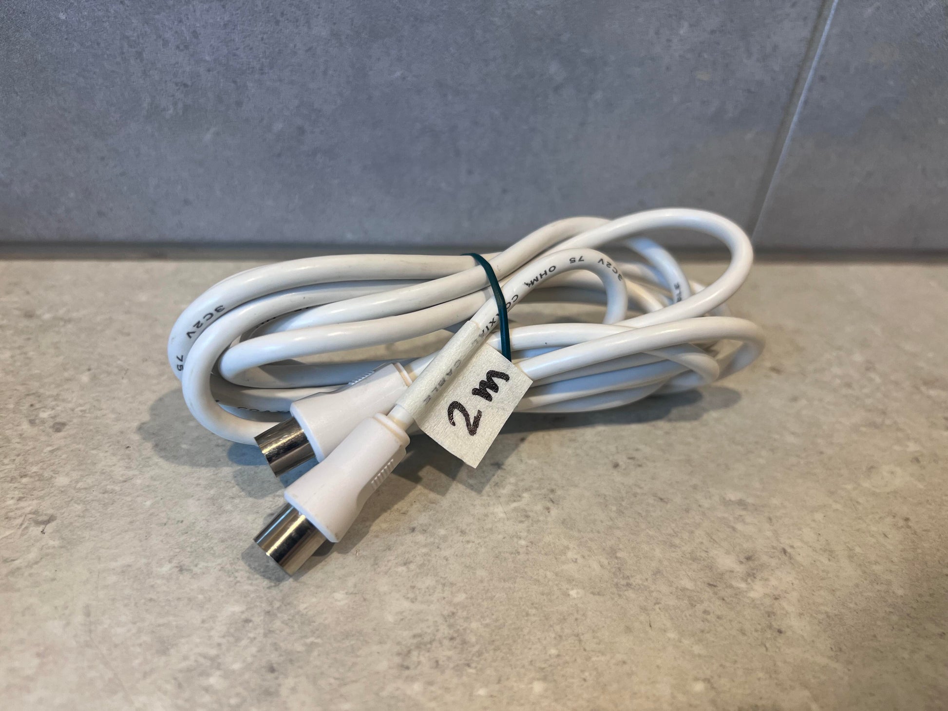 Coiled 2 meter white coaxial TV cable with metal connectors