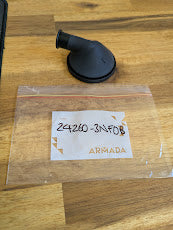 Armada rubber hose adapter fitting next to labeled plastic bag on wood surface