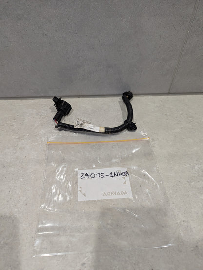 Automotive wiring harness connector assembly with black connectors and plastic bag labeled 24075-1NK0A